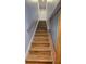 Interior shot of staircase featuring modern wood steps with a metal handrail on the side at 136 Mcleods Way, Winter Springs, FL 32708