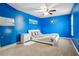 Stylish bedroom with blue walls, modern decor, and a unique bed frame at 140 Coco Plum, Davenport, FL 33897