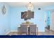 Chic dining area featuring modern light fixture, elegant art, and comfortable seating at 140 Coco Plum, Davenport, FL 33897