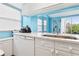 Bright kitchen with white cabinetry, stainless steel appliances, and views from the window at 140 Coco Plum, Davenport, FL 33897