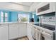 Bright kitchen with white cabinets, stainless steel appliances, and a view to the exterior at 140 Coco Plum, Davenport, FL 33897