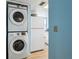 A laundry area and kitchen featuring stacked Samsung washer/dryer at 140 Coco Plum, Davenport, FL 33897