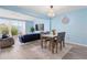 Living room with dining table and a sliding door that allows for ample natural light and great views at 140 Coco Plum, Davenport, FL 33897