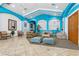 Inviting lobby area featuring tile floors, comfortable seating, and bright turquoise accents at 140 Coco Plum, Davenport, FL 33897