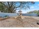 Community playground featuring multiple slides, climbing equipment, and a shady oak tree at 140 Coco Plum, Davenport, FL 33897