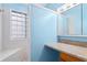 The bathroom features a glass block window and vanity storage at 140 Coco Plum, Davenport, FL 33897