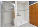 Accessible shower area with a glass door, handrails, and an adjustable shower head at 140 Coco Plum, Davenport, FL 33897