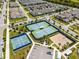 Aerial view showcasing the community's tennis and basketball courts with parking surrounded by lush landscaping at 14218 Lanikai Beach Dr, Orlando, FL 32827