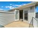 This balcony features a white railing, gray siding, and double doors leading into the home at 14218 Lanikai Beach Dr, Orlando, FL 32827