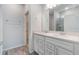 A modern bathroom featuring double sinks, white cabinets, and sleek fixtures at 14218 Lanikai Beach Dr, Orlando, FL 32827