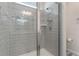 A modern bathroom featuring tiled shower with glass door and contemporary fixtures at 14218 Lanikai Beach Dr, Orlando, FL 32827