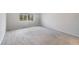 Cozy bedroom featuring plush carpeting and a large window providing natural light at 14218 Lanikai Beach Dr, Orlando, FL 32827