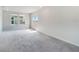 Spacious bedroom featuring plush carpeting, a window and access to a balcony at 14218 Lanikai Beach Dr, Orlando, FL 32827