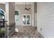 Exterior entrance featuring stone accents, double doors, and a covered brick patio at 14218 Lanikai Beach Dr, Orlando, FL 32827