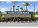 Isles of Lake Nona community sign with palm trees and landscaping at 14218 Lanikai Beach Dr, Orlando, FL 32827