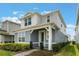 Charming two-story home with a covered entry and lush landscaping at 14218 Lanikai Beach Dr, Orlando, FL 32827