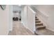 Hallway featuring wood flooring, stairs, and a glimpse into the living area at 14218 Lanikai Beach Dr, Orlando, FL 32827