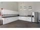 Modern clubhouse kitchen featuring white cabinets, stainless steel appliances, and ample counter space at 14218 Lanikai Beach Dr, Orlando, FL 32827