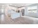 Open-concept kitchen with white cabinets, stainless steel appliances, and a center island at 14218 Lanikai Beach Dr, Orlando, FL 32827