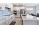 Modern kitchen with white cabinets, stainless steel appliances, and quartz countertops at 14218 Lanikai Beach Dr, Orlando, FL 32827