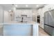 Stylish kitchen with white cabinets, stainless steel appliances, and a large center island at 14218 Lanikai Beach Dr, Orlando, FL 32827