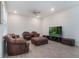 Modern living room with leather furniture, ceiling fan, and laminate flooring at 14218 Lanikai Beach Dr, Orlando, FL 32827