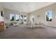 Open-concept lounge area with large windows and plenty of seating at 14218 Lanikai Beach Dr, Orlando, FL 32827