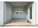 Covered brick patio with a door and window, offering a transition between indoor and outdoor living at 14218 Lanikai Beach Dr, Orlando, FL 32827
