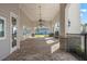 Spacious covered patio with brick flooring, ceiling fans, and stone columns, perfect for outdoor relaxation at 14218 Lanikai Beach Dr, Orlando, FL 32827