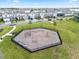 Aerial view of the fenced-in playground with modern climbing structures and swings in a residential neighborhood at 14218 Lanikai Beach Dr, Orlando, FL 32827