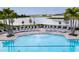 Community pool with lounge chairs and scenic views of the nearby lake at 14218 Lanikai Beach Dr, Orlando, FL 32827