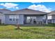 Spacious backyard with a covered patio and well-maintained lawn at 15245 Blue Peacock Ln, Winter Garden, FL 34787