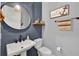 Stylish half bathroom featuring blue wood paneling and nautical decor at 15245 Blue Peacock Ln, Winter Garden, FL 34787