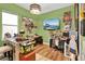 Playful bedroom with green walls and decor, wood floors, and lots of decorative wall art at 15245 Blue Peacock Ln, Winter Garden, FL 34787