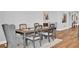 Elegant dining room with wooden table, six chairs, and a cozy rug at 15245 Blue Peacock Ln, Winter Garden, FL 34787