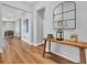 Inviting foyer with beautiful hardwood floors, a wooden table, and stylish decor at 15245 Blue Peacock Ln, Winter Garden, FL 34787