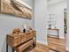Entryway with hardwood floors, wooden console table, and attractive nautical-themed artwork at 15245 Blue Peacock Ln, Winter Garden, FL 34787
