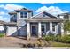 Charming home features a covered front porch, two-car garage, and beautifully landscaped yard at 15245 Blue Peacock Ln, Winter Garden, FL 34787