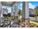 Charming front porch with stone pillars, comfortable seating, and a welcoming entrance to the home at 15245 Blue Peacock Ln, Winter Garden, FL 34787