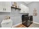 Bright laundry room with modern washer and dryer, sink, and plenty of cabinet storage at 15245 Blue Peacock Ln, Winter Garden, FL 34787