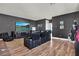Comfortable living room with dark gray walls, wood floors and luxurious leather reclining furniture at 15245 Blue Peacock Ln, Winter Garden, FL 34787