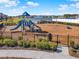 Community playground featuring slides, swings, and lake views, perfect for outdoor fun at 15245 Blue Peacock Ln, Winter Garden, FL 34787