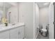 Bathroom boasts white cabinets, neutral paint, quartz countertop, and a toilet room at 2052 Milkweed St, Ocoee, FL 34761