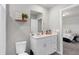 Bathroom featuring a vanity with storage and a mirror, and a door to another room at 2052 Milkweed St, Ocoee, FL 34761