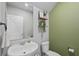 This half bathroom features a sink, mirror, toilet, and decorative shelves at 2052 Milkweed St, Ocoee, FL 34761