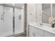 Bright bathroom featuring a glass-enclosed shower, white cabinets, and a quartz countertop at 2052 Milkweed St, Ocoee, FL 34761
