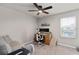 Bedroom with a ceiling fan, carpet flooring, and a desk with office chair at 2052 Milkweed St, Ocoee, FL 34761