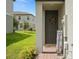 Inviting front entrance with a charming wreath, fall-themed decor, and well-maintained landscaping creates a warm welcome at 2052 Milkweed St, Ocoee, FL 34761