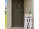Charming front door adorned with seasonal wreath and rustic decor, creating a warm and inviting entrance to the home at 2052 Milkweed St, Ocoee, FL 34761