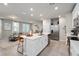 Bright, open kitchen with stainless steel appliances, tiled floors, and an island with barstool seating at 2052 Milkweed St, Ocoee, FL 34761